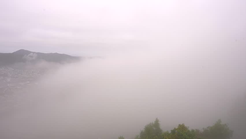 Timelapse Bergen Norway Cityscape Thick Fog Clears Early Morning to Reveal City. Norwegian Landscape From Scenic View Point