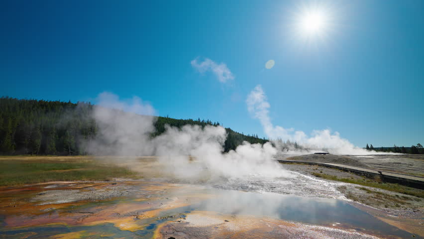Yellowstone’s geysers and hot springs attract crowds of tourists, showcasing powerful eruptions and vibrant geothermal pools in the iconic park.