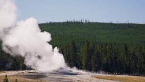 Water and steam erupt forcefully from Old Faithful in Yellowstone, as crowds gather to watch the iconic geyser’s breathtaking display of nature's power. - Powered by Shutterstock - Get 15% off with code: PIKWIZARD15