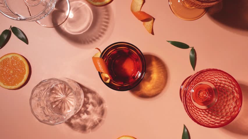 Refreshing Cocktail Drink Garnished with a Twisted Orange Peel – Elegant Beverage in 4K