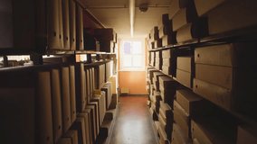 Archive storage room corridor.
Video footage of a narrow hallway in an archive storage facility lined with cardboard boxes and document folders on metal shelving units.  - Powered by Shutterstock - Get 15% off with code: PIKWIZARD15