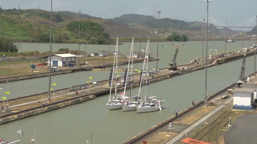 Sailboats entering Panama Canal gate in a group of three