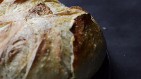 Slow Motion Pan of Freshly Baked Artisan Sourdough Bread – Golden Brown Crust with Scored Pattern Wrapped in Linen Cloth for Food Bloggers and Culinary Visuals - Powered by Shutterstock - Get 15% off with code: PIKWIZARD15