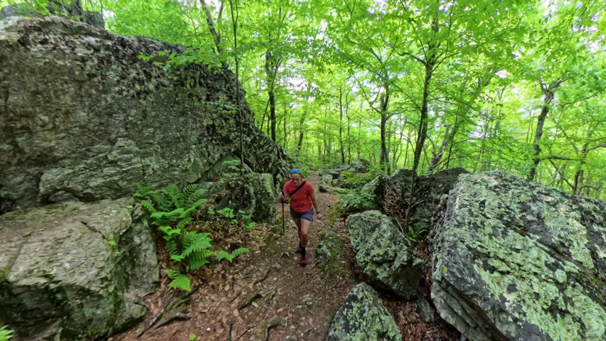 Woman Walks Uphill Through Rocks in Shenandoah National Park
