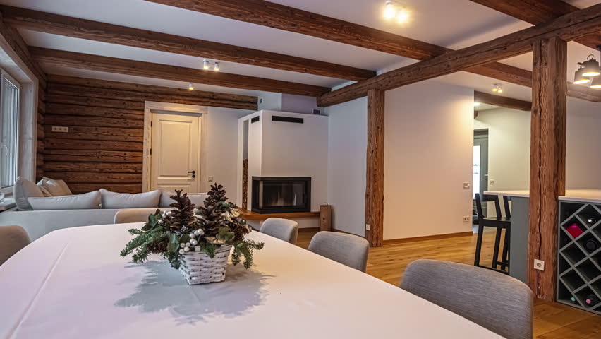 Great room in a modern cabin home - panning view of the fireplace, dining room and kitchen