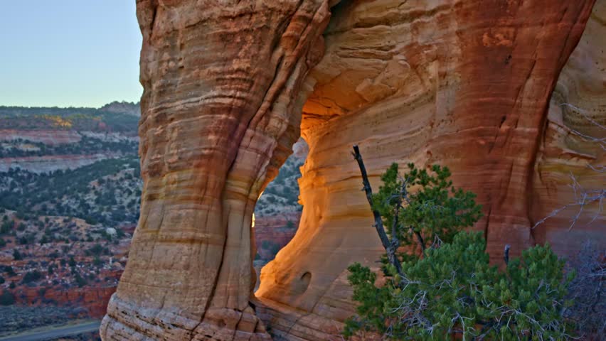 Golden-hour drone footage showcasing a stunning natural arch in Utah’s red rock country.