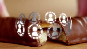 Floating digital user icons over chocolate bar on wooden surface in animation. Technology, network, innovation, communication, 3D - Powered by Shutterstock - Get 15% off with code: PIKWIZARD15