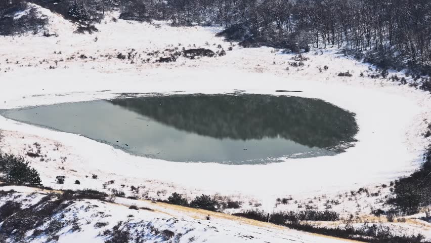 Aerial footage of the Jvari monastery, VI century, UNESCO Heritage. Drone flight over Jvari Monastery near Mtskheta, Georgia, on a sunny day, with beautiful views during daytime. Winter time, snow.