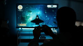 Guy spends time on television playing multiplayer web video games, setting his console into smart tv and having fun gaming at night. Player battling in shooter competition. Camera A. - Powered by Shutterstock - Get 15% off with code: PIKWIZARD15