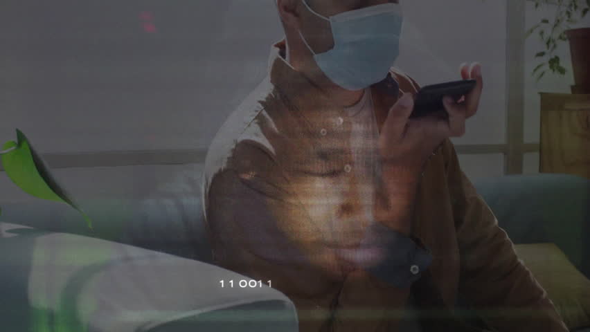 Using smartphone with digital binary code overlay, man wearing mask. Technology, cybersecurity, futuristic, protection, innovation, communication - Powered by Shutterstock - Get 15% off with code: PIKWIZARD15