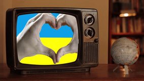 Hands Forming a Heart Shape Over the Ukrainian Flag on a Retro TV With a Spinning Globe - 4K - Powered by Shutterstock - Get 15% off with code: PIKWIZARD15