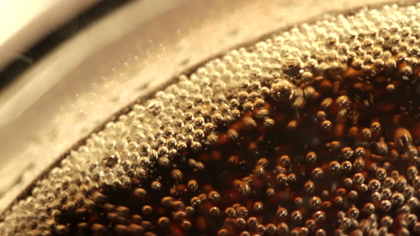 Looking down into a glass of cola. Extreme close-up recorded with macro lens.