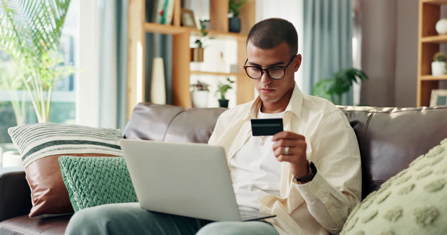 Home, sofa and man with laptop for credit card, banking app and payment for online shopping. House, glasses and happy person with digital for debit details, ecommerce and subscription for platform