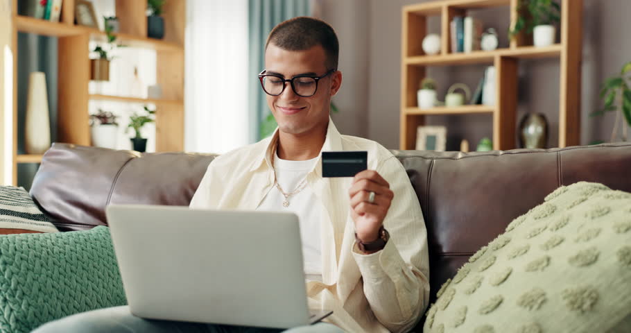 Home, sofa and man with laptop for credit card, banking app and payment for online shopping. House, glasses and happy person with digital for debit details, ecommerce and subscription for platform