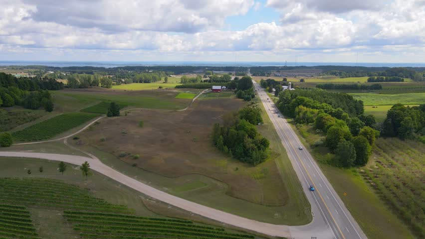 Green countryside landscape and road in Michigan, aerial view