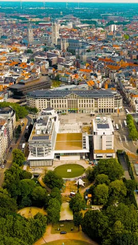Vertical video. Ghent, Belgium. Panorama of the central city from the air. Cloudy weather, summer day, Aerial View, Departure of the camera. Rich colors