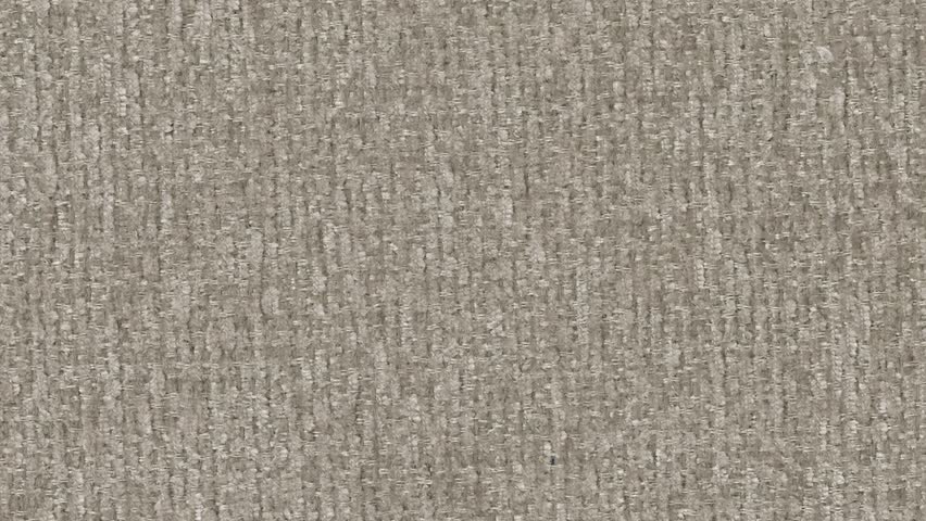 A close-up view reveals intricate brown fabric texture in refined detail