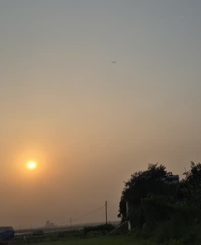 An airplane flying in the sky top of sunset 