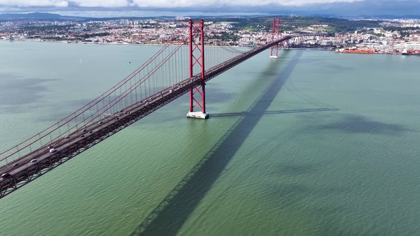 25 Of April Bridge At Lisbon In Lisbon District Portugal. Downtown City Skyline. Transportation Scenery. 25 Of April Bridge At Lisbon In Lisbon District Portugal. Famous Cable Stayed Bridge.