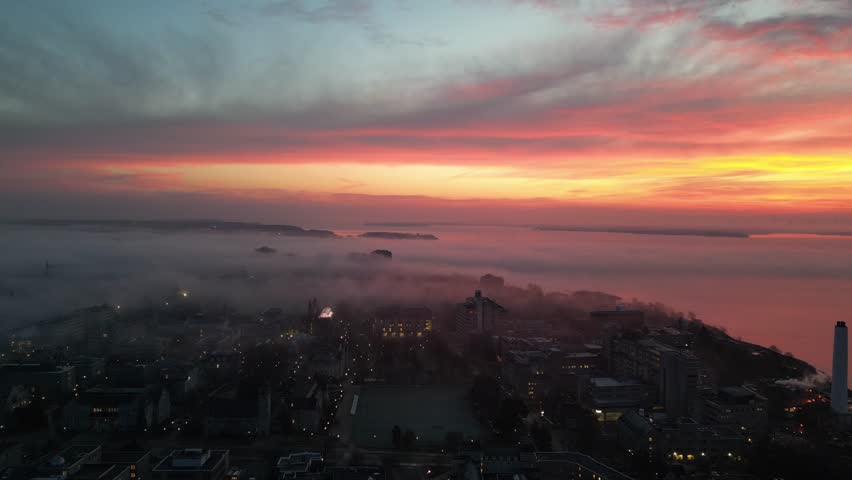 A drone view of sunset scene showing the majesty where the sky meets the earth with foggy sky