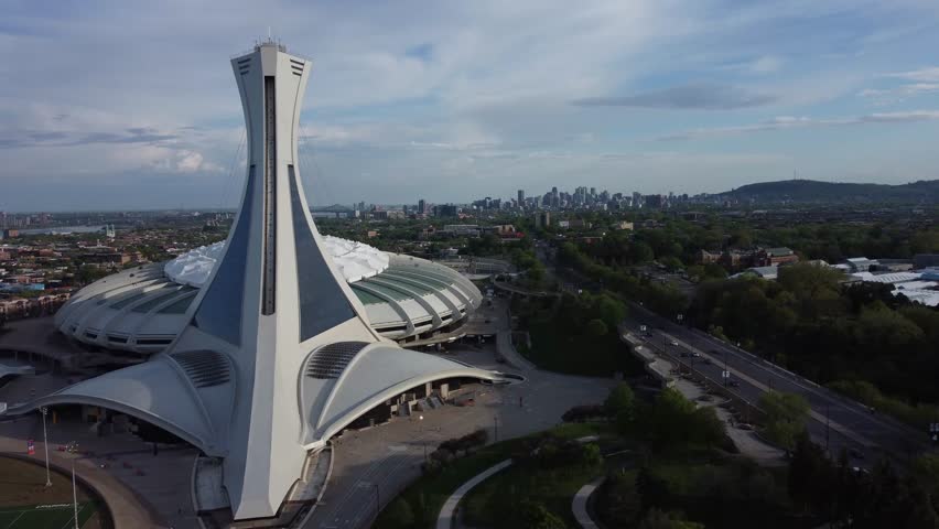 Aerial of Montreal city skyline and Mont Royal from behind Olympic Stadium