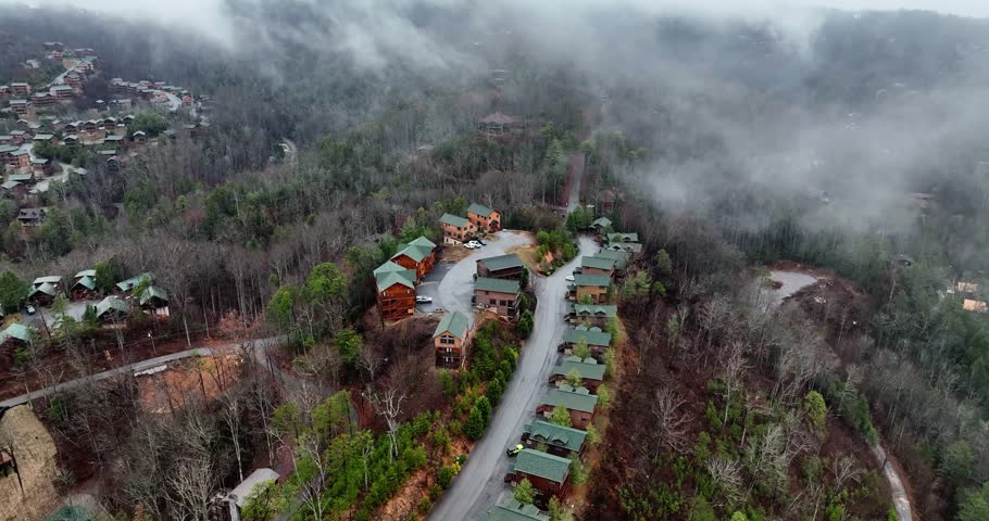 Drone view of beautiful cabins in a cloudy smoky mountain village