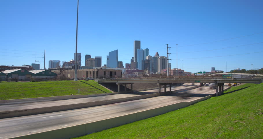 Bright sunny day I-10 East freeway timelapse of cars and downtown Houston, Texas