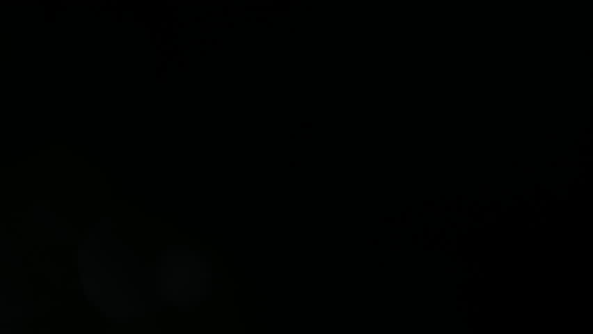 A mystical and mysterious atmosphere from the light of a flashlight on the front lens of the objective, where dust particles and water drops shimmer as bokeh in this light.