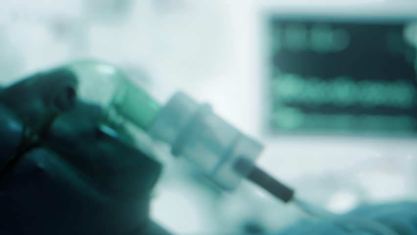 Female patient on life support with oxygen mask in hospital intensive care unit. Emergency treatment and monitoring in ICU with vital signs on screen, healthcare, medical care, and recovery treatment