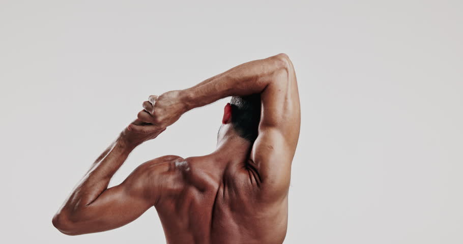 Man, back or stretching with muscle in studio for physical therapy or chiropractic exercise on a white background. Male person, muscular and warm up with loosen joints for flexibility on mockup space