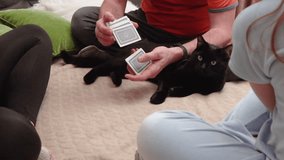 Happy family dad mom and daughter playing cards. Man shuffles a deck of playing cards - Powered by Shutterstock - Get 15% off with code: PIKWIZARD15