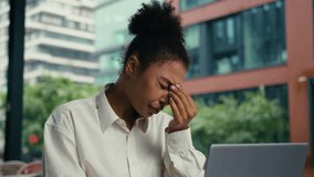 Tired African American woman headache pain head suffering overworked exhausted female girl businesswoman laptop work online employee outdoor migraine health problem medicine feel business city manager - Powered by Shutterstock - Get 15% off with code: PIKWIZARD15