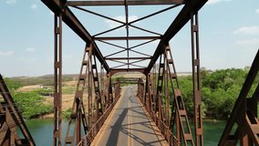 Old iron bridge, showcasing rusted beams, intricate metalwork, and a scenic river below. The aerial view highlights its historic structure, weathered details, and industrial  charm in stunning clarity - Powered by Shutterstock - Get 15% off with code: PIKWIZARD15