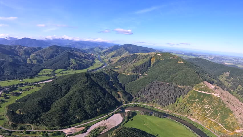 Stunning aerial shot flying up the Motueka valley in New Zealand on a sunny day