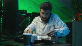 Indian Arabian man talking mobile phone freelancer guy male problem lost mistake stressed worried anxiety programmer code hacker computer cyberspace cryptocurrency check bills trouble coder smartphone - Powered by Shutterstock - Get 15% off with code: PIKWIZARD15