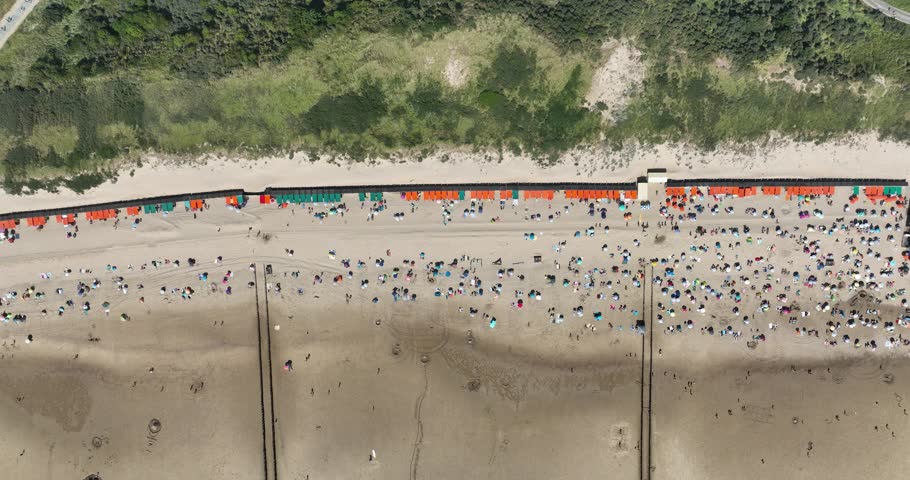 Aerial top down view on a summer beach in the Netherlands. Leisure sun bathing recreation. Zeeland, The Netherlands.