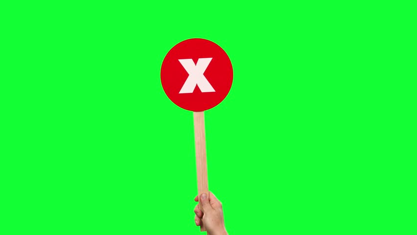A hand waving a red X paddle. Green screen. Game show concept.	