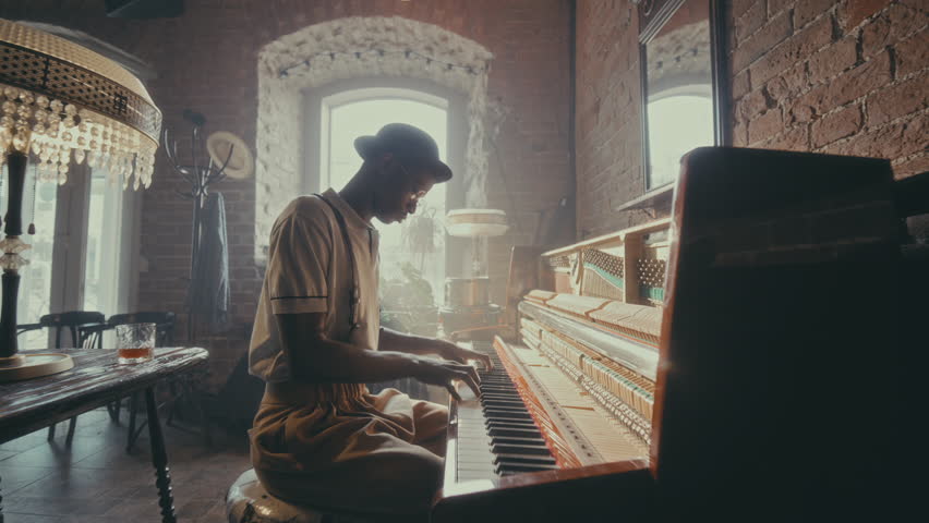 African American jazz performer dressed in elegant retro outfit, immersed in music, playing piano and leaning into the rhythm in vintage cafe filled with sunshine. Whip zoom shot