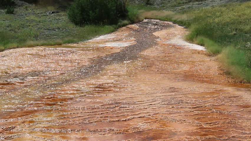 Mammoth Hot Springs and associated geothermal features in Yellowstone Park, Wyoming. Colours are created by various bacteria and sulphur deposits. Some dolly movement in this shot.