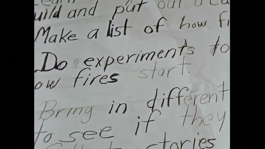 UNITED STATES - 1954 - Miss Patterson helps the students create a better chart. Books on fire safety and firemen are gathered from the library and home.