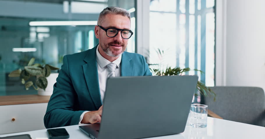 Mature, businessman or excited with laptop for good news, business deal or winning at office. Happy man, employee or investor with smile or fist pump on computer for profit, investment or opportunity
