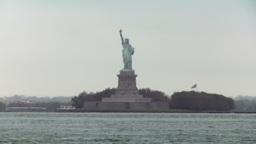 Statue of Liberty seen from Brooklyn, New York, USA. Early morning with a small