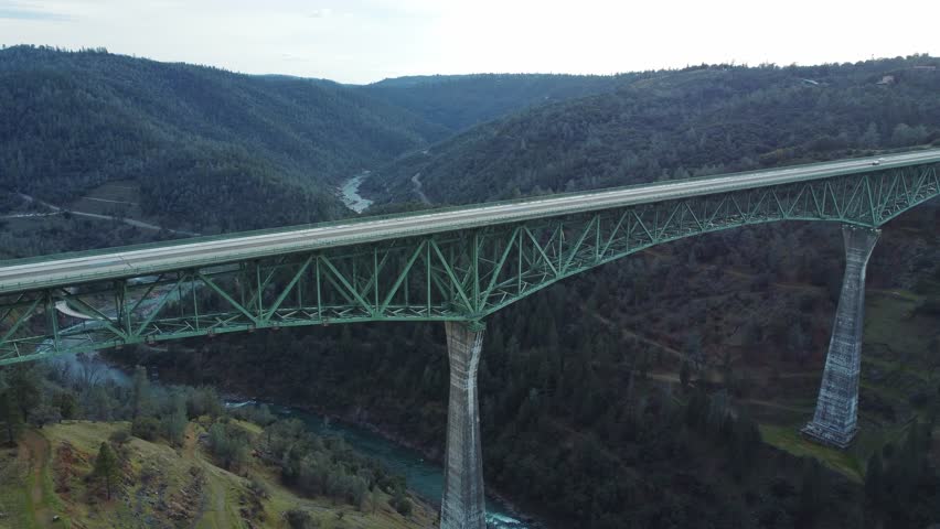 Drone Footage. Drone flying forward over Foresthill Bridge in a scenic mountain valley