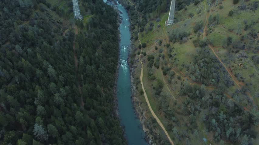 Drone Footage. Vertical drone ascent under Foresthill Bridge revealing landscape