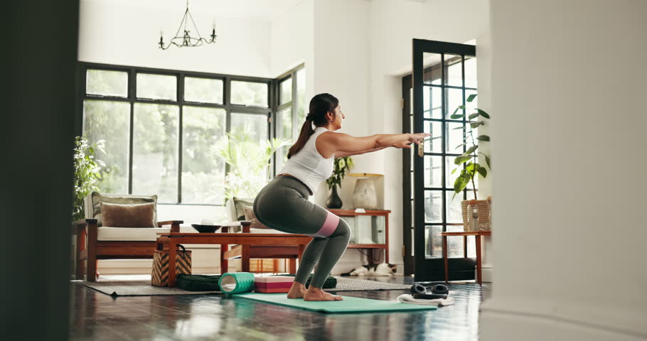 Yoga, resistance band and woman squat in home for exercise, workout and training for muscle strength. Morning, house and person for wellness, health and stretching for pilates, balance or flexibility