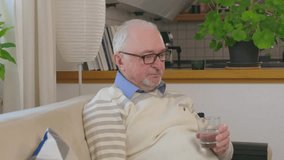 side view, old man drinking glass of water sitting on sofa Water is health concept. Drinking glass of water concept.  - Powered by Shutterstock - Get 15% off with code: PIKWIZARD15