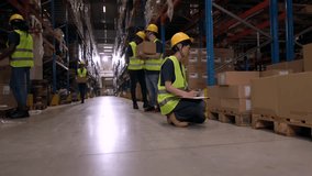Warehouse workers wearing safety vests and helmets are checking inventory, lifting boxes, and managing logistics in a busy distribution center - Powered by Shutterstock - Get 15% off with code: PIKWIZARD15