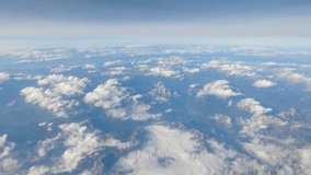 Cumulus clouds over the mountainous terrain, view from an airplane side window during a flight at high altitude
 - Powered by Shutterstock - Get 15% off with code: PIKWIZARD15