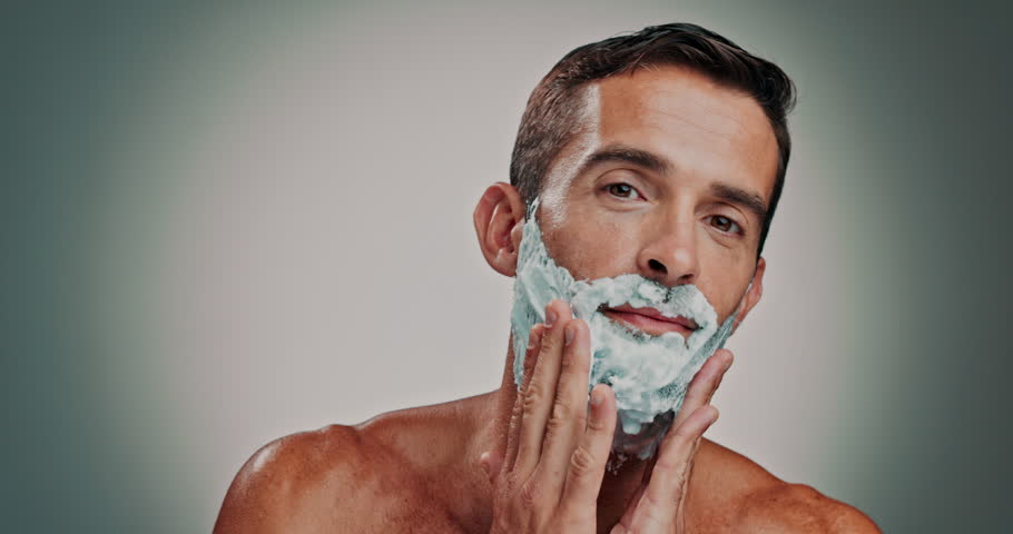 Face, man and foam with shaving for skincare, hair removal and facial hygiene for self care. Portrait, person and product with grooming routine, dermatology cream and maintenance in studio background