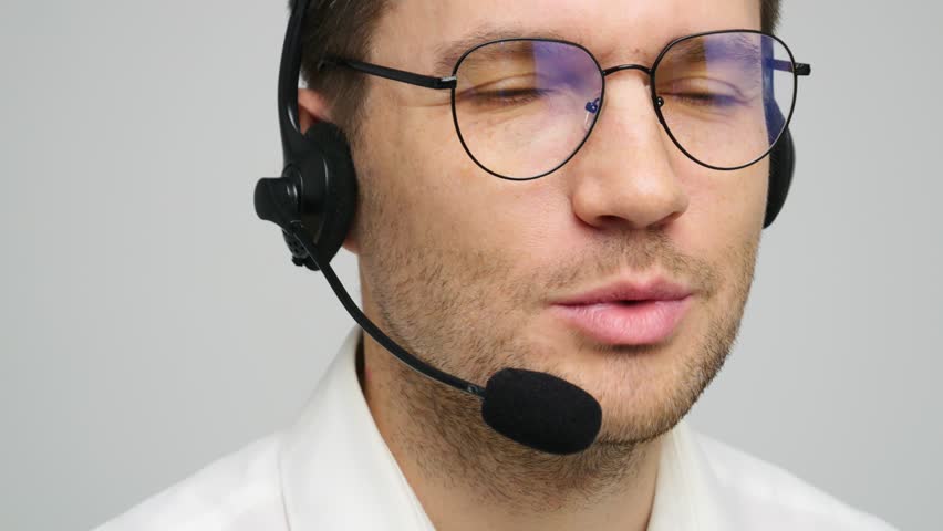 Professional man wearing headset smiling while providing customer support in a modern office - Powered by Shutterstock - Get 15% off with code: PIKWIZARD15